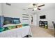 This bedroom offers carpeted floors, a ceiling fan, and decor shelving with storage at 8227 Bird Whistle Ln, Land O Lakes, FL 34637