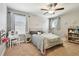 Bedroom with carpeted floor, ceiling fan, and a window bringing in plenty of natural light at 8227 Bird Whistle Ln, Land O Lakes, FL 34637
