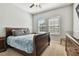 Inviting bedroom featuring a large bed, ceiling fan, and bright windows at 8227 Bird Whistle Ln, Land O Lakes, FL 34637