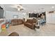 Open-concept living room with tile flooring, neutral walls, ceiling fan, and open to the kitchen at 8227 Bird Whistle Ln, Land O Lakes, FL 34637