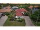 Aerial view of a beautiful home with a red tiled roof and a well-maintained lawn and garden at 915 Live Oak Ne Ter, St Petersburg, FL 33703