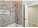 Bathroom with a tub, shower, and tiled walls with a built-in shelf for toiletries at 915 Live Oak Ne Ter, St Petersburg, FL 33703