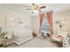 Bedroom features a white crib and rocking chair, complemented by soft colors and natural light at 915 Live Oak Ne Ter, St Petersburg, FL 33703