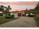 Beautiful single Gathering home with a red tile roof, red garage door, and well manicured yard at 915 Live Oak Ne Ter, St Petersburg, FL 33703