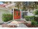 Close up of the front entrance with red double doors, beautiful landscaping, and a brick pathway at 915 Live Oak Ne Ter, St Petersburg, FL 33703