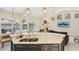 Open-concept kitchen with stainless appliances, marble countertops and a view of the living room and pool at 915 Live Oak Ne Ter, St Petersburg, FL 33703
