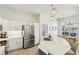 Bright kitchen featuring stainless steel appliances, pendant lighting, and a marble countertop island at 915 Live Oak Ne Ter, St Petersburg, FL 33703