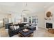 Spacious living room featuring a fireplace, view of the kitchen, and sliding doors to the outdoor area at 915 Live Oak Ne Ter, St Petersburg, FL 33703