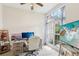Comfortable home office with a large window providing natural light and a desk with dual monitors at 915 Live Oak Ne Ter, St Petersburg, FL 33703