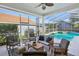 Comfortable screened in patio with cushioned seating, overlooking a private pool and backyard at 915 Live Oak Ne Ter, St Petersburg, FL 33703