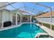 Beautiful pool area with spa, sun loungers, and a screened enclosure providing an outdoor oasis at 915 Live Oak Ne Ter, St Petersburg, FL 33703