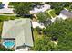 Aerial view of the home showcasing landscaping and screened pool at 9159 Highland Ridge Way, Tampa, FL 33647