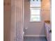 Bathroom featuring tiled shower with curtain, window, vanity, and linoleum flooring at 9159 Highland Ridge Way, Tampa, FL 33647