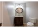 Cozy toilet room featuring a vanity, a mirror, and neutral colors at 9159 Highland Ridge Way, Tampa, FL 33647