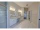 Luxurious bathroom with dual sinks, glass vessel sinks, and a walk-in shower at 9159 Highland Ridge Way, Tampa, FL 33647