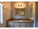 Bright bathroom featuring a vanity with granite countertops, decorative lighting, and large mirror at 9159 Highland Ridge Way, Tampa, FL 33647