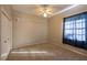 A bright bedroom features neutral walls, carpeted floors, a ceiling fan, and a window with light-blocking curtains at 9159 Highland Ridge Way, Tampa, FL 33647