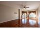 Bright bedroom featuring wood floors, a ceiling fan, and a sliding glass door at 9159 Highland Ridge Way, Tampa, FL 33647