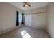 Bedroom featuring a closet with sliding doors, a window with curtains, and neutral carpet at 9159 Highland Ridge Way, Tampa, FL 33647
