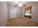 Neutral bedroom featuring carpet, a ceiling fan, closet, and window with curtains at 9159 Highland Ridge Way, Tampa, FL 33647