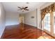 Bedroom featuring hardwood floors, ceiling fan, and a sliding glass door at 9159 Highland Ridge Way, Tampa, FL 33647