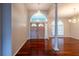 Bright entryway features hardwood floors, a chandelier, double doors, and sidelight windows at 9159 Highland Ridge Way, Tampa, FL 33647