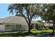 View of the home showcasing meticulous landscaping and a unique architectural style at 9159 Highland Ridge Way, Tampa, FL 33647