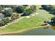 Expansive golf course with sand traps, mature trees and a pond bordering the green at 9159 Highland Ridge Way, Tampa, FL 33647