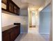 Tiled hallway with a bar counter on the left and access to other rooms at 9159 Highland Ridge Way, Tampa, FL 33647