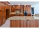 Spacious kitchen featuring wooden cabinets, granite countertops, stainless steel appliances, and tile flooring at 9159 Highland Ridge Way, Tampa, FL 33647