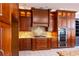 Gourmet kitchen with custom wood cabinetry, granite counters, and stainless steel appliances at 9159 Highland Ridge Way, Tampa, FL 33647
