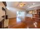 Open-concept living room with wood floors, fireplace, and seamless access to kitchen and outdoor patio at 9159 Highland Ridge Way, Tampa, FL 33647