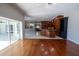 Open-concept living space showcasing wood floors, fireplace, kitchen, dining nook and backyard access at 9159 Highland Ridge Way, Tampa, FL 33647
