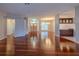 Bright, open-concept living space with hardwood floors and archways to the front entryway at 9159 Highland Ridge Way, Tampa, FL 33647