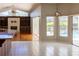 Open-concept living space showcasing fireplace, living room, dining nook and backyard pool access at 9159 Highland Ridge Way, Tampa, FL 33647