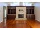 Cozy living room with a fireplace and custom shelving for storage and decor at 9159 Highland Ridge Way, Tampa, FL 33647