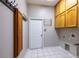 The mudroom features tile floors, coat rack, cabinets and a bright white door at 9159 Highland Ridge Way, Tampa, FL 33647