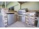 Outdoor kitchen featuring stone accents, stainless steel BBQ, and refrigerator at 9159 Highland Ridge Way, Tampa, FL 33647