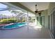 Covered patio with ceiling fan overlooking the screened pool at 9159 Highland Ridge Way, Tampa, FL 33647