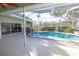 Screened in pool and lanai area featuring an outdoor kitchen at 9159 Highland Ridge Way, Tampa, FL 33647