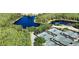 Aerial view of a community featuring tennis courts nestled near a serene lake at 9159 Highland Ridge Way, Tampa, FL 33647