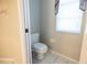Small toilet room featuring neutral colors, tiled flooring, and a window at 9159 Highland Ridge Way, Tampa, FL 33647