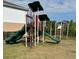 Community playground with slide, ladders and black metal fence at 9508 Ashburn Creek Ln, Tampa, FL 33610