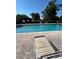 Community pool with lounge chairs and brick surround at 9508 Ashburn Creek Ln, Tampa, FL 33610