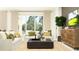 Bright living room with modern furniture, green accents and a view of the outdoors at 9684 Minnow Ray Dr, Land O Lakes, FL 34638