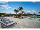 Relaxing pool area offers lounge chairs, shade, and lush greenery, creating a tranquil escape at 9684 Minnow Ray Dr, Land O Lakes, FL 34638