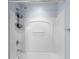 Modern tub and shower with contemporary fixtures and wall-mounted storage at 10212 Westpark Preserve Blvd, Tampa, FL 33625