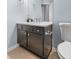 Well-lit bathroom has a granite countertop vanity with modern fixtures and cabinet storage at 10212 Westpark Preserve Blvd, Tampa, FL 33625