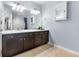 Bathroom featuring double sinks, vanity, ample lighting, and a medicine cabinet for a spa-like experience at 10212 Westpark Preserve Blvd, Tampa, FL 33625
