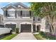 Charming home with gray exterior, dark shutters, two-car garage, and a manicured lawn at 10212 Westpark Preserve Blvd, Tampa, FL 33625